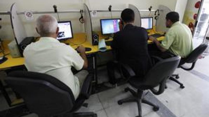 People surf the Internet at an Internet cafe in Baghdad November 11, 2012. Iraqi telecommunications operators have warned that government plans to charge for the extra spectrum which they need to launch long-awaited 3G services could slow Internet adoption and economic growth. Picture taken November 11, 2012. To match story IRAQ-TELECOMS/  REUTERS/Mohammed Ameen (IRAQ - Tags: BUSINESS TELECOMS SCIENCE TECHNOLOGY SOCIETY)