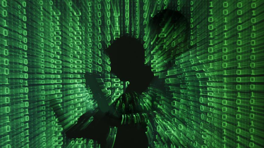 An illustration picture shows a projection of binary code on a man holding a laptop computer, in an office in Warsaw June 24, 2013. REUTERS/Kacper Pempel (POLAND - Tags: BUSINESS TELECOMS TPX IMAGES OF THE DAY) - RTX10ZB5