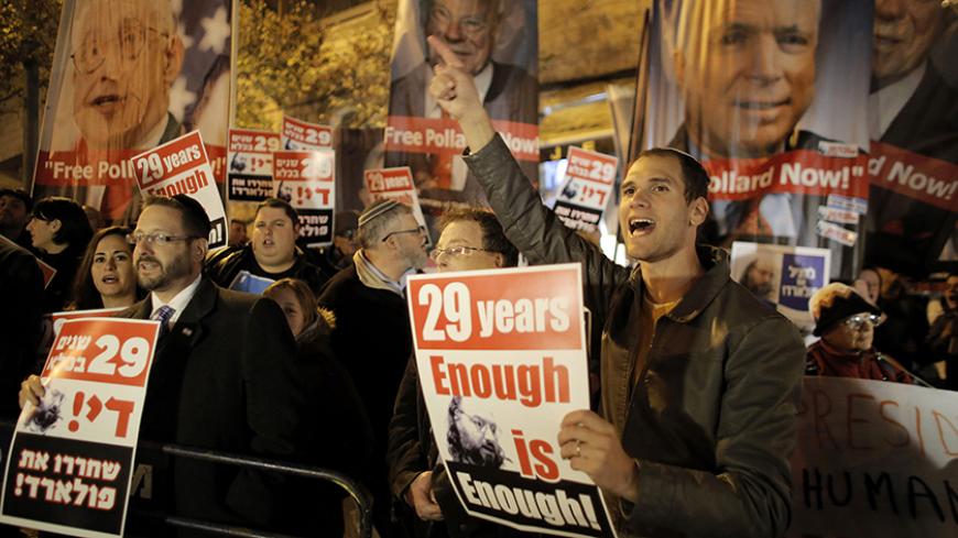 Israelis hold placards during a protest calling for the release of Jonathan Pollard from a U.S. prison, outside U.S. Secretary of State John Kerry's hotel in Jerusalem January 2, 2014. Kerry began his 10th visit to the region on Thursday in pursuit of an Israeli-Palestinian peace deal. Pollard, a former U.S. Navy intelligence analyst, has been serving a life sentence in the United States since he was caught spying for Israel in the 1980s. REUTERS/Ammar Awad (JERUSALEM - Tags: POLITICS CIVIL UNREST) - RTX170