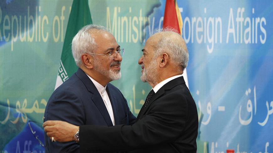 Iraqi Foreign Minister Ibrahim al-Jaafari (R) welcomes his Iranian counterpart Mohammad Javad Zarif in Baghdad, July 27, 2015. REUTERS/Ahmed Saad - RTX1M0DY