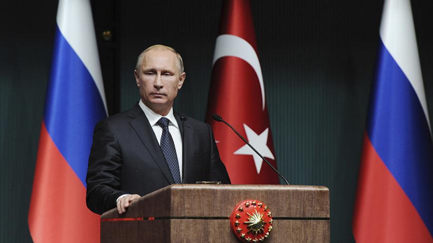 Russia's President Vladimir Putin is pictured during a joint news conference with his Turkish counterpart Tayyip Erdogan (not pictured) in Ankara December 1, 2014. Putin said on Monday that Moscow could not carry on with the South Stream project if the European Union was opposed to it. Speaking at a joint news conference with Turkish President Erdogan, Putin said the European Commission was reluctant to give the green light to the South Stream project.  REUTERS/Mikhail Klimentyev/RIA Novosti/Kremlin (TURKEY