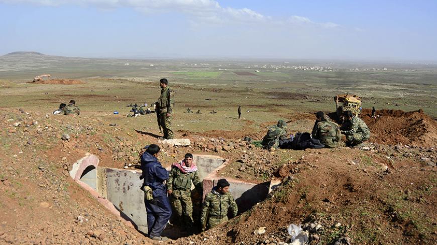 Fighters loyal to Syria's President Bashar Al-Assad rest on a hill after regaining control of Tal Fatima, a town south of Damascus, in the Daraa countryside March 1, 2015. Government forces say they've regained control of this and many other villages in the south - wresting them back from rebel hands.A general made the announcement on state television, saying a large number of Nusra Front fighters were killed and their weapons destroyed. The gains were said to happen on Friday and Saturday in a large offens
