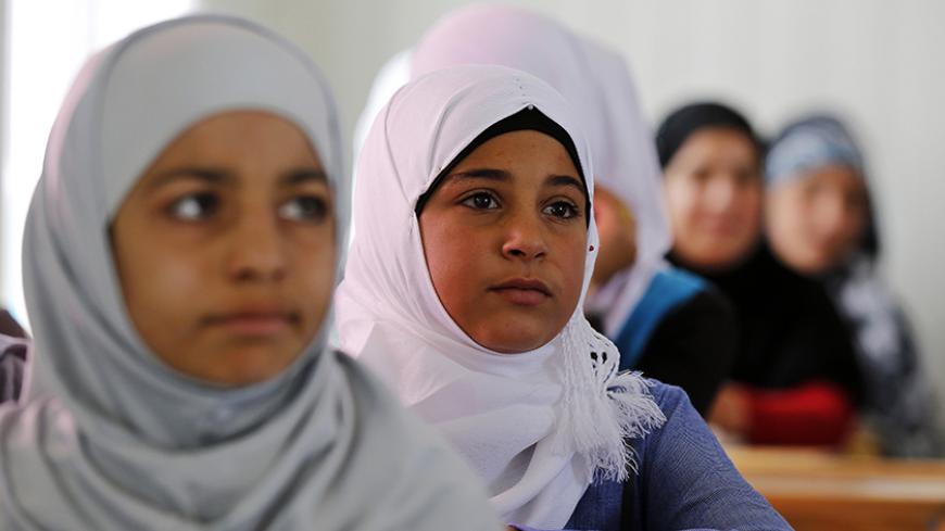 Syrian refugee children attend class in a UNICEF school at the Al Zaatari refugee camp in the Jordanian city of Mafraq, near the border with Syria March 11, 2015. Nearly four million people have fled Syria since 2011, when anti-government protests turned into a violent civil war. Jordan says it is sheltering around 1.3 million refugees.  REUTERS/Muhammad Hamed (JORDAN - Tags: CIVIL UNREST CONFLICT SOCIETY IMMIGRATION EDUCATION) - RTR4SZK1