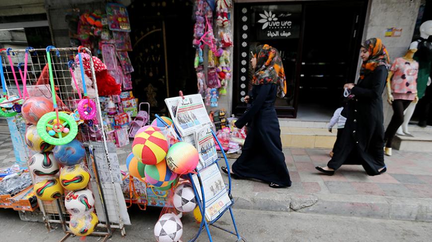 Palestinians walk past local newspapers, which feature the Israeli election on their front pages, in Khan Younis in the southern Gaza Strip, March 18, 2015. As the dust settles on a dramatic election, the immediate questions are how Prime Minister Benjamin Netanyahu managed to stage such a fierce comeback, why the opposition fell short and what it means for Israel, the Palestinians and the world. While the election results may come down to the shuffling of allegiances within major blocs, the repercussions a