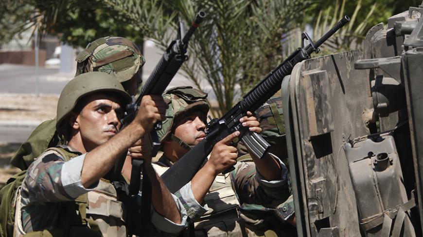 Lebanese army soldiers point their weapons during clashes with gunmen of hardline Sunni Muslim cleric Sheikh Ahmed al-Assir, in Abra near Sidon, southern Lebanon, June 24, 2013. Lebanese soldiers fought Sunni Muslim gunmen in the southern city of Sidon on Monday in one of the deadliest outbreaks of violence fuelled by sectarian divisions over the civil war in neighbouring Syria. REUTERS/Sharif Karim  (LEBANON - Tags: POLITICS CIVIL UNREST MILITARY) - RTX10YUO