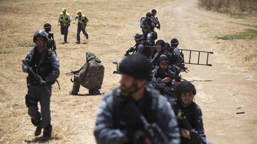 Israeli policemen secure the area during a drill simulating a bomb attack on a train in Kiryat Gat, Israel June 4, 2015. Israel completed a five-day annual home front defence exercise on Thursday, preparing soldiers and civilians for attacks. REUTERS/Amir Cohen - RTX1F36V