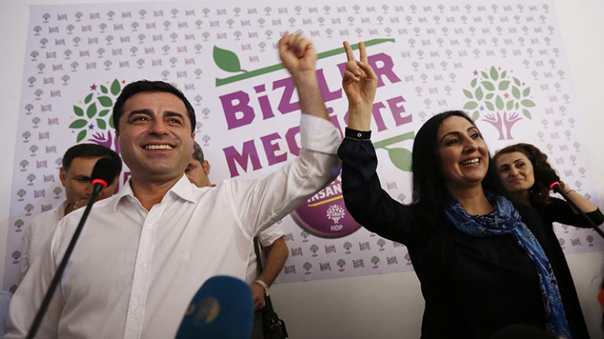 Co-chairs of the pro-Kurdish Peoples' Democratic Party (HDP), Selahattin Demirtas (L) and Figen Yuksekdag celebrate inside party's headquarters in Istanbul, Turkey, June 7, 2015. Partial results from Turkey's parliamentary election on Sunday put the ruling AK Party on 43.6 percent of the vote, with just under two-thirds of ballots counted, a level which could leave it struggling to form a single-party government. The results, broadcast by CNN Turk, put the pro-Kurdish Peoples' Democratic Party (HDP) at 10.6