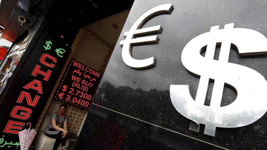 A woman sits at a money exchange office in central  Istanbul, Turkey, June 8, 2015. The Turkish lira traded near a record lows on Monday as nervous investors reacted to the prospects of a minority or coalition government after the ruling AK Party failed to win a majority in a parliamentary election. The lira, already one of the worst performing emerging market currencies this year, hit a record low in out-of-hours trade on Sunday, after results showed the AKP had taken just short of 41 percent of the vote. 