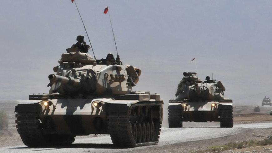 Turkish tanks move on a road outside the southeastern Turkish town of Silopi, near the Iraqi border, October 9, 2008. A senior Iraqi Kurdish official warned Turkey on Thursday against stationing troops inside Iraq and said such a move would not stop cross-border raids by Kurdish guerrillas.  REUTERS/Stringer  (TURKEY) - RTX9D1P
