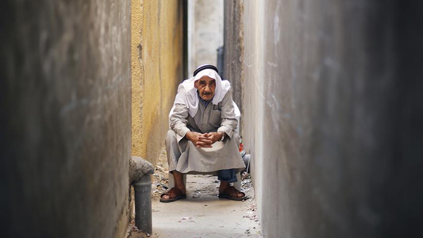 Palestinian refugee Khamis Redwan, 75, poses for a photograph between the narrow alleys of Jabalya refugee camp in the northern Gaza Strip May 14, 2013. Redwan said he was 10 years old when he was forced out of his native town with his family to the Gaza Strip. Palestinians will mark "Nakba" (Catastrophe) on May 15 to commemorate the expulsion or fleeing of some 700,000 Palestinians from their homes in the war that led to the founding of Israel in 1948.   REUTERS/Suhaib Salem (GAZA - Tags: CIVIL UNREST POLI