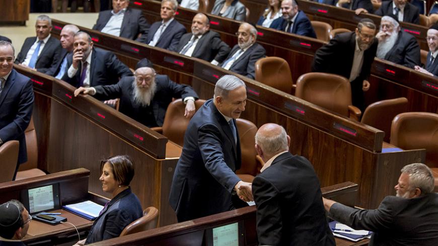 Israeli Prime Minister Benjamin Netanyahu (C) shakes hands with members of the opposition after he was sworn-in as Prime Minister for the fourth time, to lead the 34th Israeli government, at the Knesset, the Israeli parliament, in Jerusalem May 14, 2015. Netanyahu's new rightist coalition government, hobbled from the outset by its razor-thin parliamentary majority, was sworn in late on Thursday amid wrangling within his Likud party over cabinet posts. Picture taken May 14, 2015. REUETRS/Jim Hollander/Pool -