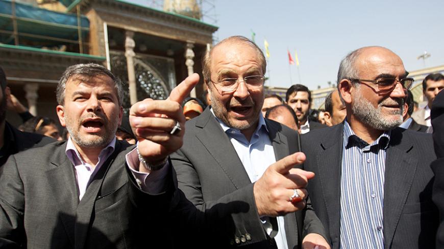 Tehran's mayor and presidential candidate, Mohammad Baqer Ghalibaf (C) arrives to vote in the first round of the presidential election on June 14, 2013 at a polling station at Shah Abdolazim mausoleum in southern Tehran. Iranians are voting to choose a new president in an election the reformists hope their sole candidate will win in the face of divided conservative ranks, four years after the disputed re-election of Mahmoud Ahmadinejad. AFP PHOTO/BEHROUZ MEHRI        (Photo credit should read BEHROUZ MEHRI/