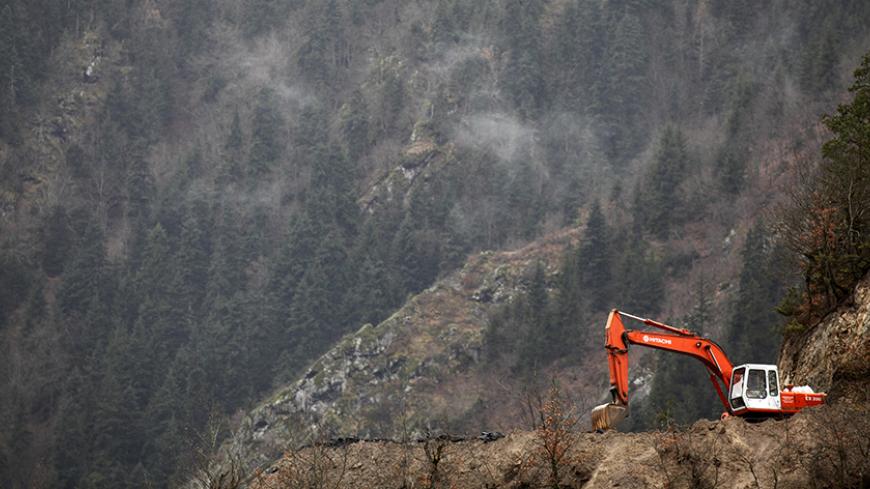 A digger works on the bed stream of the river Papart in Artvin province, northern Turkey, February 21, 2010. A civil initiative calling themselves "Brotherhood of the Rivers" is struggling to stop hydro power plant projects in Artvin province which they believe will damage the natural habitat badly. Turkey's Electricity Market Regulatory Authority has approved 357 hydro power plant projects in the last three years, said Turkey's Chamber of Electrical Engineer. REUTERS/Umit Bektas (TURKEY - Tags: ENERGY ENVI