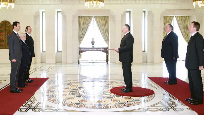 Syrian President Bashar al-Assad (L) receives Russia's new ambassador to Syria Alexander Kinschaka (C) in Damascus, in this February 9, 2015 handout photo by Syria's national news agency SANA. REUTERS/SANA/Handout via Reuters (SYRIA - Tags: POLITICS) ATTENTION EDITORS - THIS PICTURE WAS PROVIDED BY A THIRD PARTY. REUTERS IS UNABLE TO INDEPENDENTLY VERIFY THE AUTHENTICITY, CONTENT, LOCATION OR DATE OF THIS IMAGE. THIS PICTURE IS DISTRIBUTED EXACTLY AS RECEIVED BY REUTERS, AS A SERVICE TO CLIENTS. EDITORIAL U