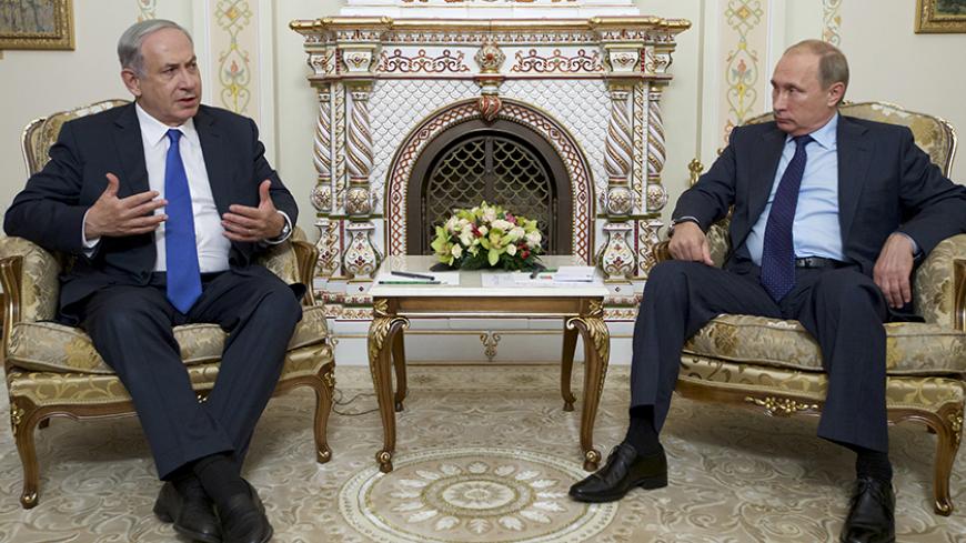 Israeli Prime Minister Benjamin Netanyahu (L) speaks with Russian President Vladimir Putin during their meeting at the Novo-Ogaryovo state residence outside Moscow, Russia, September 21, 2015. Netanyahu said his visit to Moscow on Monday was aimed at preventing clashes between Russian and Israeli military forces in the Middle East. REUTERS/Ivan Sekretarev/Pool - RTS25BW