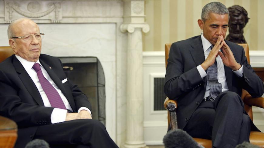 U.S. President Barack Obama (R) and Tunisia's President Beji Caid Essebsi (L) listen to the translations as they deliver remarks to reporters after their meeting in the Oval Office at the White House in Washington May 21, 2015.  REUTERS/Jonathan Ernst - RTX1DZY4