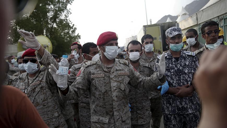 Saudi security forces block the way to an area where a stampede occurred at the camp city at Mina, near the holy city of Mecca September 24, 2015. At least 717 pilgrims from around the world were killed on Thursday in a crush outside the Muslim holy city of Mecca, Saudi authorities said, in the worst disaster to strike the annual haj pilgrimage for 25 years. REUTERS/Ahmad Masood - RTX1SAS4