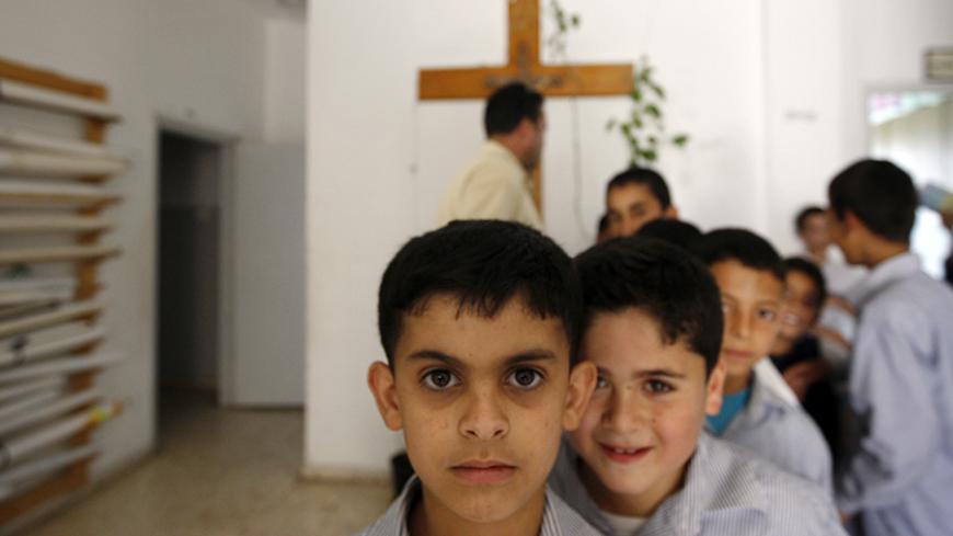 Palestinian students walk in the hallway of their school run by the Parish of Our Lady Mother of Sorrows in the West Bank village of Aboud May 18, 2009. Israel's land barrier is slowly destroying the fabric of this Palestinian village of Christians and Muslims in the West Bank, residents say, setting a prime example of why the United States wants settlements to stop.  To match feature ISRAEL-PALESTINIANS/FENCE   
REUTERS/Ammar Awad (WEST BANK POLITICS CONFLICT EDUCATION RELIGION) - RTXIRX8
