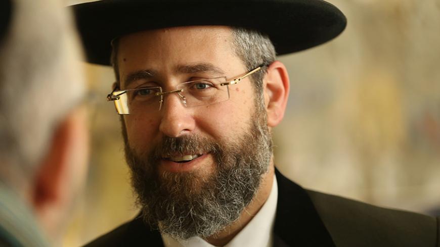 BERLIN, GERMANY - NOVEMBER 08:  David Lau, Ashkenazi Chief Rabbi of Israel, speaks to a man at the Or Avner traditional Jewish school ahead of the 75th anniversary of the Kristallnacht pogroms on November 8, 2013 in Berlin, Germany. Germany is commemorating the 75th anniversary of the Kristallnacht pogroms, during which Nazi gangs burned down synagogues, smashed shops and looted residences across Germany and Austria in a fury of anti-semitic violence in 1938. Persecution of Jews was a central component of A