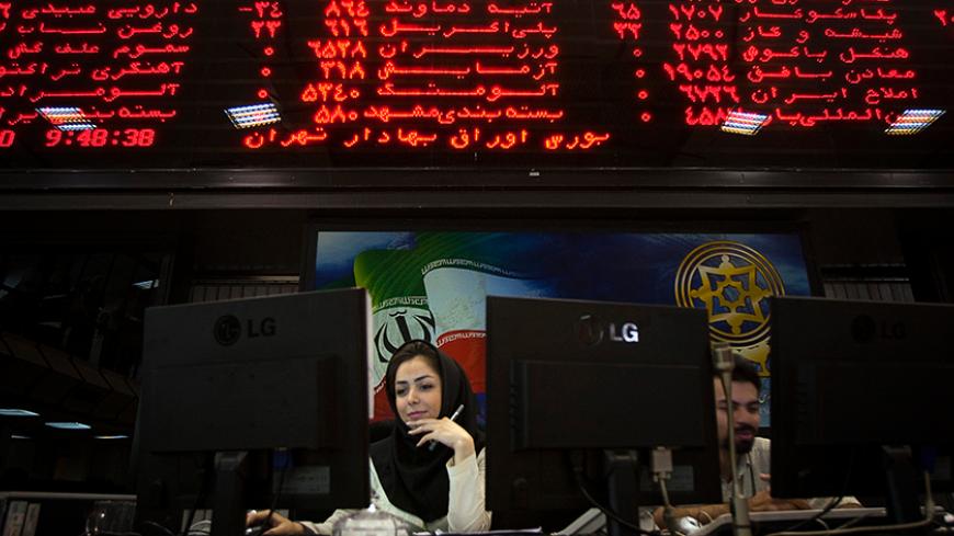 EDITORS' NOTE:  Reuters and other foreign media are subject to Iranian restrictions on their ability to film or take pictures in Tehran.

An Iranian official works at her desk in the main hall of the Tehran Stock Exchange August 3, 2010. Sanctions against Iran have done nothing to dent a boom in its stock market, as investors bet on a continued rise in company stocks which have been undervalued for years, the head of the Tehran bourse said.    REUTERS/Morteza Nikoubazl (IRAN - Tags: BUSINESS POLITICS) - RTR