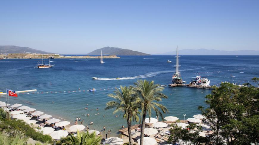 Holidaymakers rest at a beach in the resort town of Bodrum July 14, 2014. As families splash in the sea and lounge in the sun, thoughts of politics and civic duty are a world away for most Turks holidaying on the Aegean and Mediterranean coasts. Only the most committed opponents of Prime Minister Tayyip Erdogan leave the beach to queue in a sweltering council building nearby to register to vote in next month's presidential election to prevent what they see as the country's slide towards authoritarianism. Th