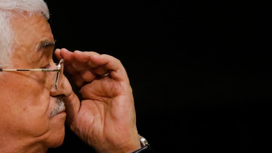 Palestinian President Mahmoud Abbas adjusts his eyeglasses as he waits to address attendees during the 70th session of the United Nations General Assembly at the U.N. headquarters in New York, September 30, 2015.   REUTERS/Carlo Allegri - RTS2H3P