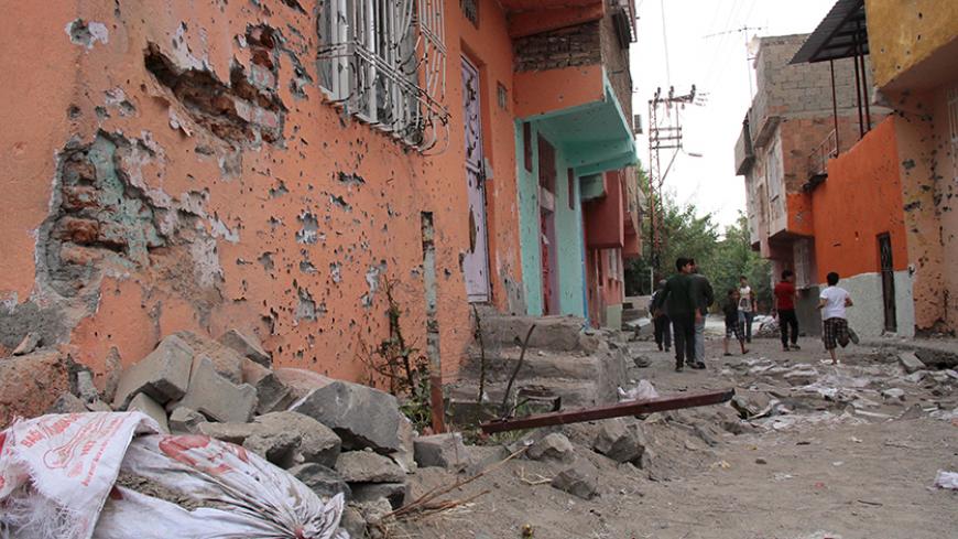 Children play between damaged building after a security operation in Sur district in the Kurdish dominated southeastern city of Diyarbakir, Turkey, October 13, 2015. A top Kurdistan Workers Party (PKK) commander was quoted on Monday as saying the group would stick to a unilateral ceasefire announced at the weekend despite Turkish air strikes against its positions in southeast Turkey and northern Iraq. Unrest continued elsewhere in the mainly Kurdish region, with the historic Sur district of Diyarbakir city 