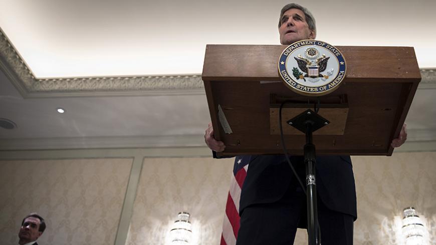 U.S. Secretary of State John Kerry holds a press conference as senior advisor John Kirby (L) looks on following a day of meetings in Vienna, October 23, 2015. REUTERS/Carlo Allegri - RTS5VLA