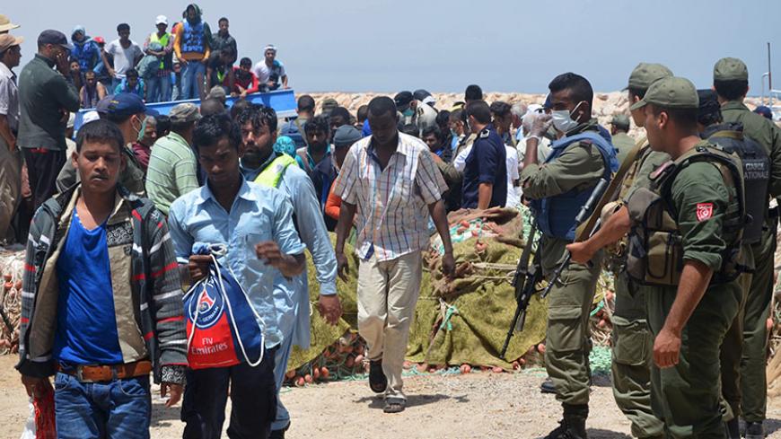 Illegal migrants disembark as they arrive in Ben Guerdane, Tunisia, June 10, 2015. Tunisia's navy rescued more than 350 illegal migrants off its coast and was searching for hundreds more on Wednesday after they tried to sail from neighbouring Libya to the Italian island of Lampedusa, the local Red Cross said. REUTERS/Stringer - RTX1G08U