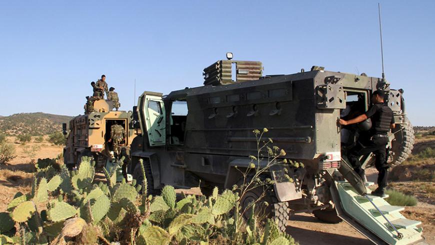 Tunisian soldiers and police patrol the area of Mount Salloum near Algeria's border in Kasserine, Tunisia July 4, 2015. Tunisian President Beji Caid Essebsi declared a state of emergency on Saturday, saying the Islamist militant attack on a beach hotel that killed 38 foreigners had left the country "in a state of war". Picture taken July 4, 2015. REUTERS/Stringer - RTX1J484