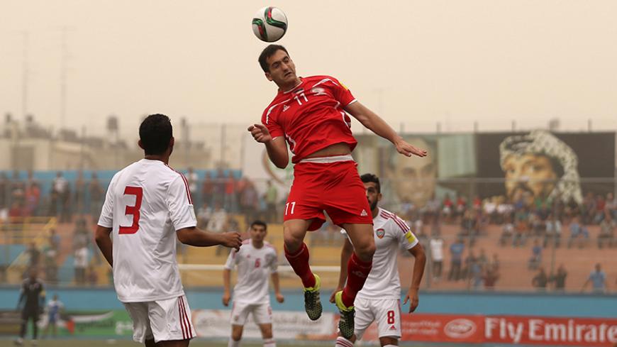 Matias Hadwa of Palestine jumps for a header during their 2018 World Cup qualifying soccer match against the United Arab Emirates at Faisal al-Husseini Stadium in the occupied West Bank town of Al-Ram near Jerusalem September 8, 2015. REUTERS/Mohamed Torokman - RTX1ROFK