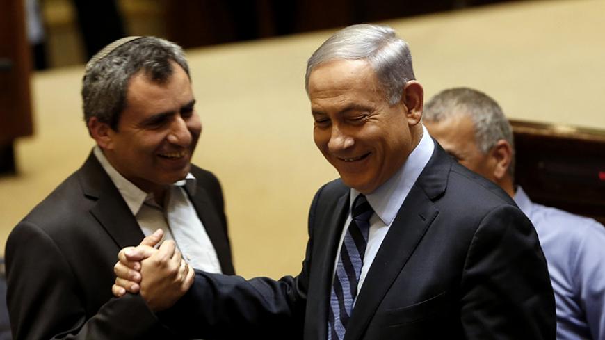 Israeli Prime Minister Benjamin Netanyahu (C) talks with Likud Knesset member Ze'ev Elkin (L) during a meeting at the parliament, the Knesset, in Jerusalem, on May 13, 2015, to vote on a bill to increase the number of ministers permitted. Netanyahu's fledgling coalition passed its first test in a deeply divided parliament when it passed the bill by 61 votes to 59. AFP PHOTO / GALI TIBBON (Photo credit should read GALI TIBBON/AFP/Getty Images)