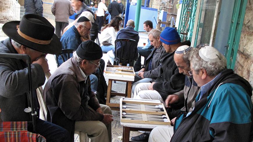 TO GO WITH AFP STORY BY RON BOUSSO
Israeli Jews of Iraqi origin play backgammon at the Iraqi area of Jerusalem's landmark Mahne Yehuda market on November 26, 2009. Signs of the changing times can be seen throughout the maze of narrow streets that make up Mahne Yehuda, which is known to locals simply as the "Shuk" -- Hebrew for market. AFP PHOTO/MARINA PASSOS (Photo credit should read MARINA PASSOS/AFP/Getty Images)