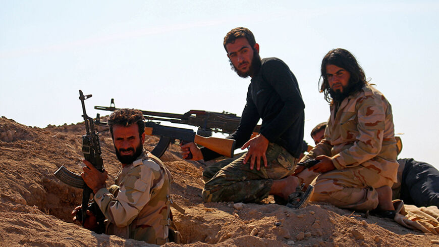Rebel fighters hold their weapons as they take their positions on which forces loyal to Syria's President Bashar al-Assad are carrying out offensives to take control of the town of Kafr Nabudah in Hama province, Syria October 11, 2015. The Syrian army backed by allied militia has advanced in western Syria after heavy Russian air strikes in areas around the main highway running through major cities, a group monitoring the war said on Sunday. REUTERS/Ammar Abdullah  - RTS7DAC