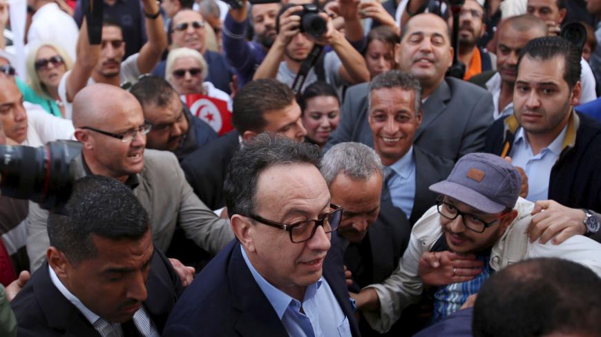 Hafhed Caid Essebsi (C), son of Tunisian president Beji Caid Essebsi, arrives for a meeting with leaders of the Nidaa Tounes party in Tunis, Tunisia November 3, 2015. Tensions between two wings of Nidaa Tounes, whose name means Call of Tunis, spilled over into violence last week when a party meeting descended into open fighting with fists and sticks. A split within Nidaa Tounes could trigger political instability in the country that launched the first of the Arab Spring revolutions in 2011. Thirty-two of Ni