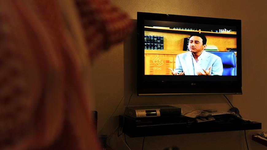 A Saudi man watches the most popular Saudi TV series during the holy fasting month of Ramadan "Tash Ma Tash" in the Red Sea port city of Jeddah on August 22, 2010. Turning the tables on conservative Islamic beliefs, "Tash ma Tash" has again sparked huge laughs and huge controversy this month by depicting a Muslim woman not just married to four husbands, but also wanting to divorce one of them in order to marry someone else. AFP PHOTO/AMER HILABI (Photo credit should read AMER HILABI/AFP/Getty Images)