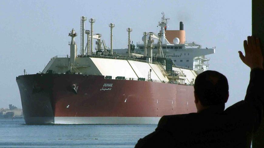 A man looks as the world's biggest Liquefied Natural Gas (LNG) tanker DUHAIL as she crosses through the Suez Canal April 1, 2008. The Qatari tanker, which was built to transfer LNG from Qatar to Europe and the U.S., is on her first trip ever from Qatar to Spain. REUTERS/Stringer (EGYPT) - RTR1YZYN