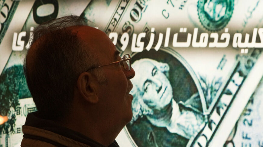 EDITORS' NOTE: Reuters and other foreign media are subject to Iranian restrictions on leaving the office to report, film or take pictures in Tehran.

An Iranian man walks past a currency exchange shop in northern Tehran January 3, 2012. The Iranian rial fell to a record low against the dollar on Tuesday following U.S. President Barack Obama signing a bill on  imposing fresh sanctions against the country's central bank.   REUTERS/Morteza Nikoubazl (IRAN - Tags: BUSINESS POLITICS) - RTR2VU6Z