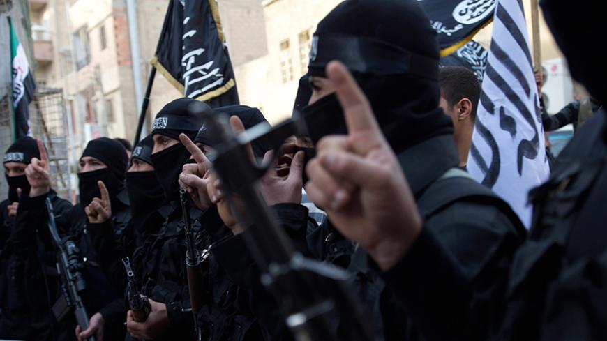 Members of an Islamist group hold their weapons during a protest against Syria's President Bashar al-Assad's regime in Deir el-Zor, February 25, 2013. Picture taken February 25, 2013. REUTERS/Khalil Ashawi (SYRIA - Tags: CONFLICT) - RTR3EAXZ