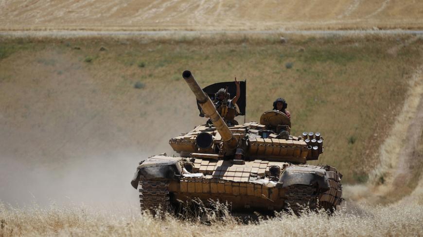 Islamist Syrian rebel group Jabhat al-Nusra drive a tank on Al-Khazan frontline of Khan Sheikhoun, northern Idlib province May 17, 2014. REUTERS/Hamid Khatib (SYRIA - Tags: CIVIL UNREST MILITARY POLITICS CONFLICT) - RTR3PM99