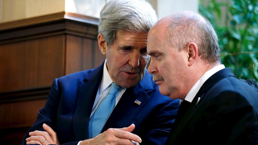 U.S. Secretary of State John Kerry (L) speaks with Turkey's Foreign Minister Feridun Sinirlioglu on the sidelines as their two heads of state address reporters at the Regnum Carya Resort in Antalya, Turkey, November 15, 2015.  REUTERS/Jonathan Ernst - RTS753C