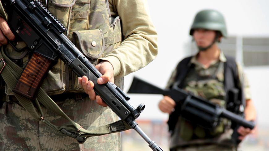 Turkish soldiers stand guard at a check point on the main road between Mardin and Cizre near the southeastern town of Midyat, Turkey, September 9, 2015. A deteriorating security situation in Turkey's mainly Kurdish southeast where a ceasefire between government forces and Kurdish insurgents has broken down, will make it difficult to hold an election planned for November, the head of the pro-Kurdish Peoples' Democratic Party (HDP) said on Wednesday. Turkey's southeast has seen almost daily clashes between mi
