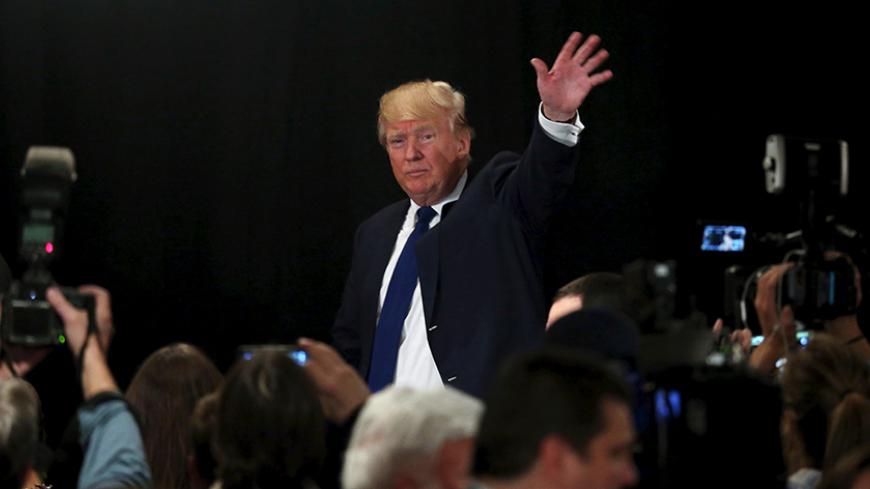 U.S. Republican presidential candidate Donald Trump waves as he leaves the stage after receiving the endorsement of the New England Police Benevolent Association in Portsmouth, New Hampshire December 10, 2015.     REUTERS/Mary Schwalm - RTX1Y6A7