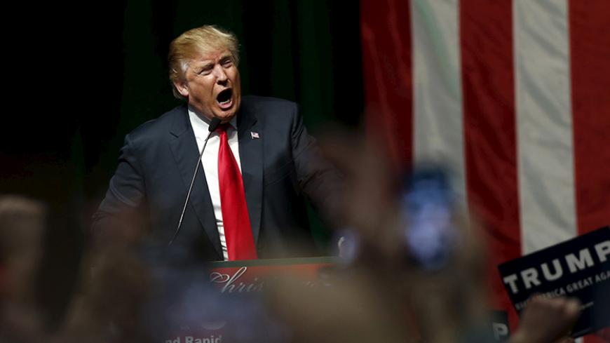 U.S. Republican presidential candidate Donald Trump addresses the crowd during a campaign rally in Grand Rapids, Michigan, December 21, 2015. REUTERS/Rebecca Cook - RTX1ZT14