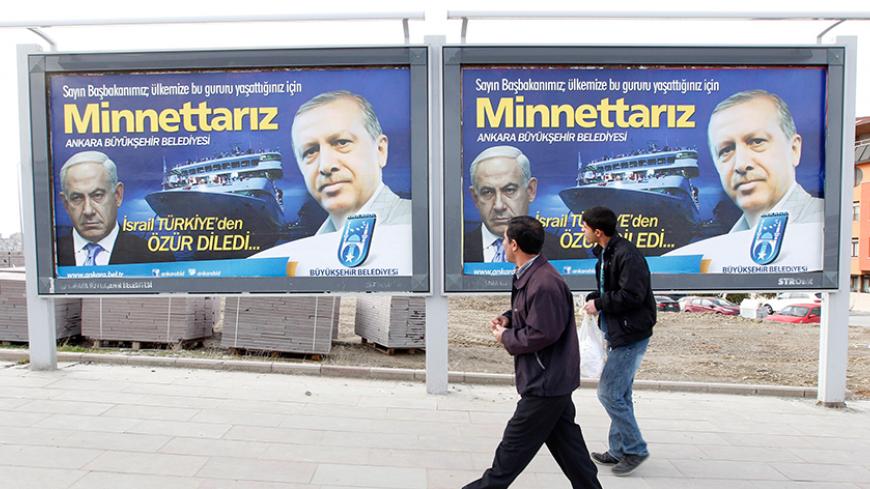Pedestrians look at billboards with the pictures of Turkey's Prime Minister Tayyip Erdogan (R) and his Israeli counterpart Benjamin Netanyahu (L), in Ankara March 25, 2013. Turkey's Prime Minister Tayyip Erdogan said on Saturday an Israeli apology for the 2010 deaths of nine Turkish pro-Palestinian activists that was brokered by U.S. President Barack Obama met Turkey's conditions and signalled its growing regional clout. The billboard reads, "Israel apologized to Turkey. Dear Prime Minister (Erdogan), We ar