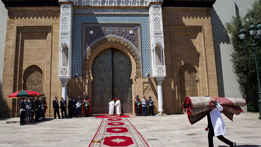 A worker carries carpets during preparation for the arrival of U.S. Secretary of State John Kerry for his meeting with Morocco's King Mohammed VI at the royal palace in Casablanca, April 4, 2014. REUTERS/Jacquelyn Martin/Pool (MOROCCO - Tags: POLITICS) - RTR3K0QF