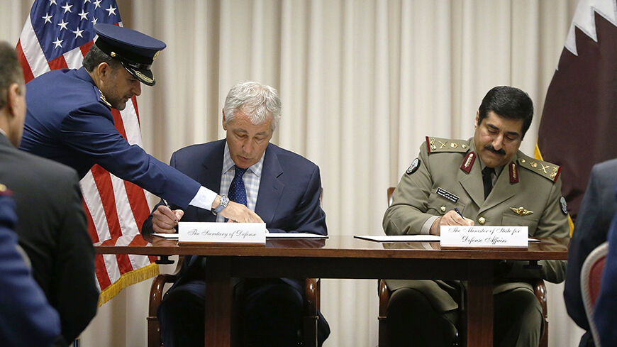 U.S. Secretary of Defense Chuck Hagel (L) and Qatar's Minister of State for Defense Affairs Hamad bin Ali al Attiyah sign an arms system agreement at the Pentagon in Arlington, Virginia July 14, 2014. REUTERS/Jonathan Ernst    (UNITED STATES - Tags: POLITICS MILITARY) - RTR3YM6O