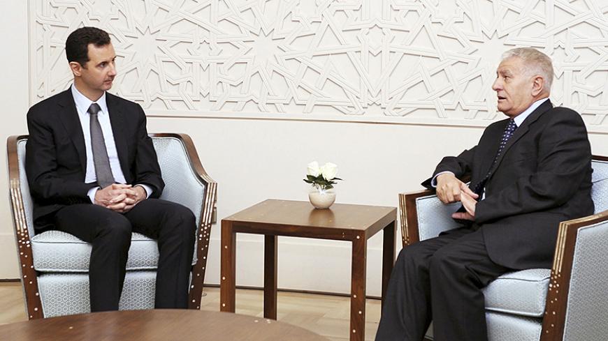 Syria's President Bashar al-Assad (L) meets Abbas Zaki, the personal envoy of the Palestinian President Mahmoud Abbas, in Damascus, in this handout photograph distributed by Syria's national news agency SANA on October 7, 2013. REUTERS/SANA/Handout via Reuters (SYRIA - Tags: POLITICS) ATTENTION EDITORS - THIS IMAGE WAS PROVIDED BY A THIRD PARTY. FOR EDITORIAL USE ONLY. NOT FOR SALE FOR MARKETING OR ADVERTISING CAMPAIGNS. THIS PICTURE IS DISTRIBUTED EXACTLY AS RECEIVED BY REUTERS, AS A SERVICE TO CLIENTS -