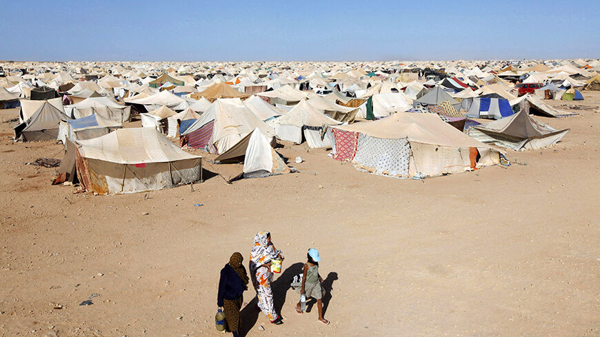 Saharawi women walk at the protest camp on the outskirts of Western Sahara's main city, Laayoune, November 6, 2010. The thousands in this camp amount to be the biggest protest in three decades in Western Sahara, a former Spanish colony annexed by Morocco in 1975 and now the subject of Africa's longest-running territorial dispute. However, the protesters are steering clear of the status question and are focusing instead on bread-and-butter issues: they say they want the Moroccan government to provide more jo