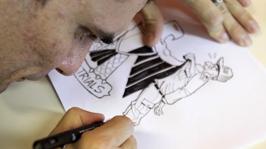 Brazilian cartoonist Carlos Latuff finalizes a cartoon after an interview with Reuters in Rio de Janeiro August 26, 2011. Latuff, a 42-year-old leftist whose only family link to the Middle East is a Lebanese grandfather he never knew, has become a hero of the tumultuous Arab Spring with rapid-fire satirical sketches that have helped inspire the uprisings. All he has needed is his pen, a passion for the region's struggles and a Twitter account. Starting with the Tunisia uprisings last December, Latuff's work